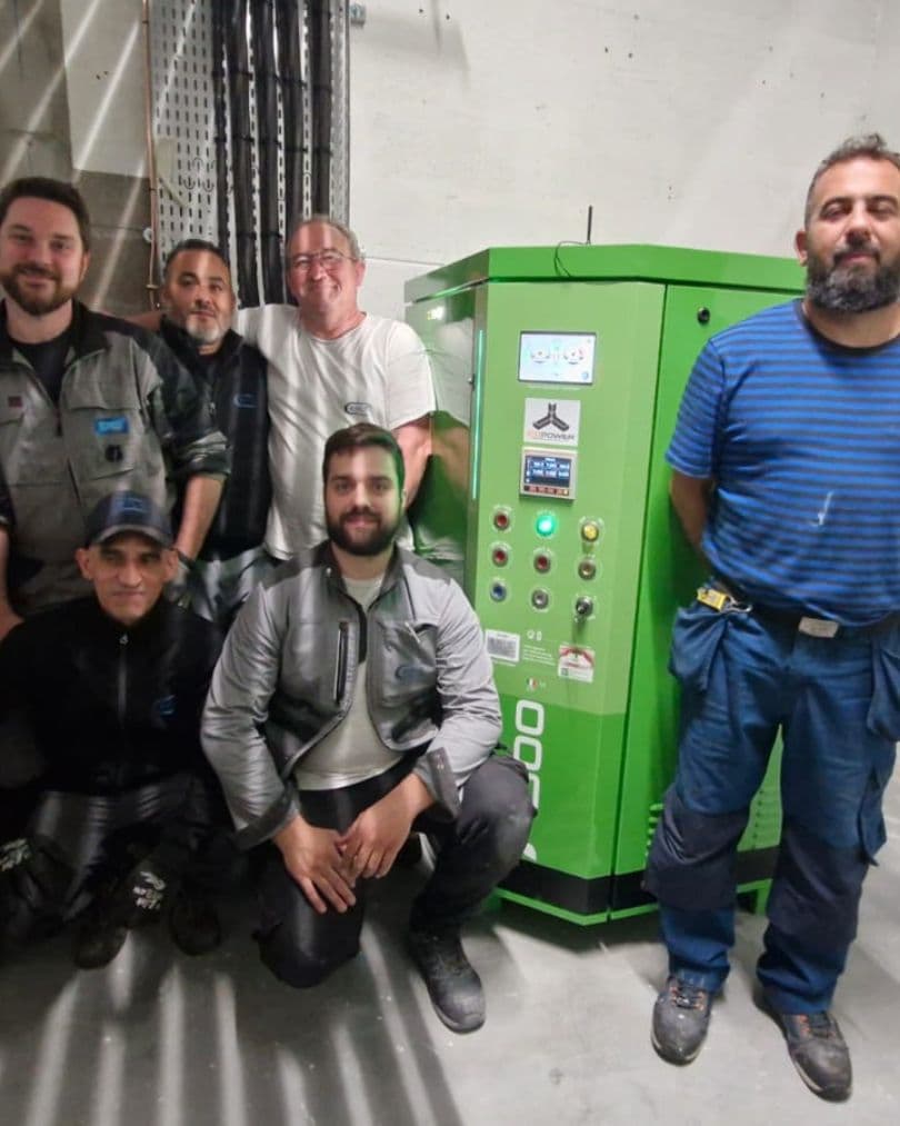 Installation team beside a commissioned Icopower F1000